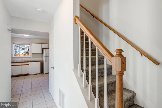 a view of a hallway with kitchen and entryway