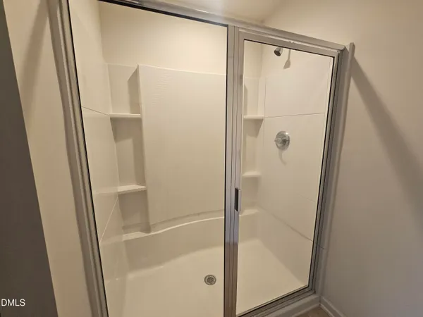 a bathroom with a glass shower door