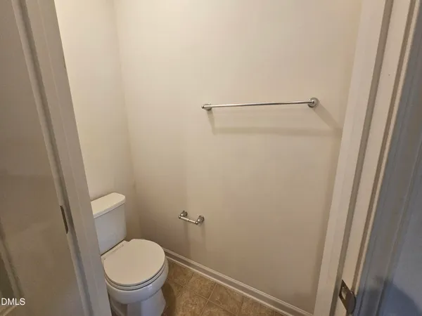a white toilet sitting next to a shower