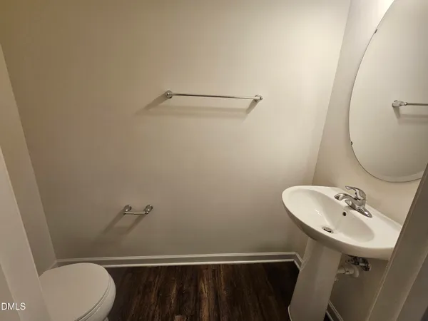 a bathroom with a sink toilet and a mirror