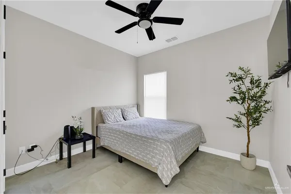 a bedroom with a bed and a plant