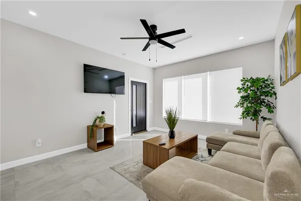 a living room with furniture and a flat screen tv