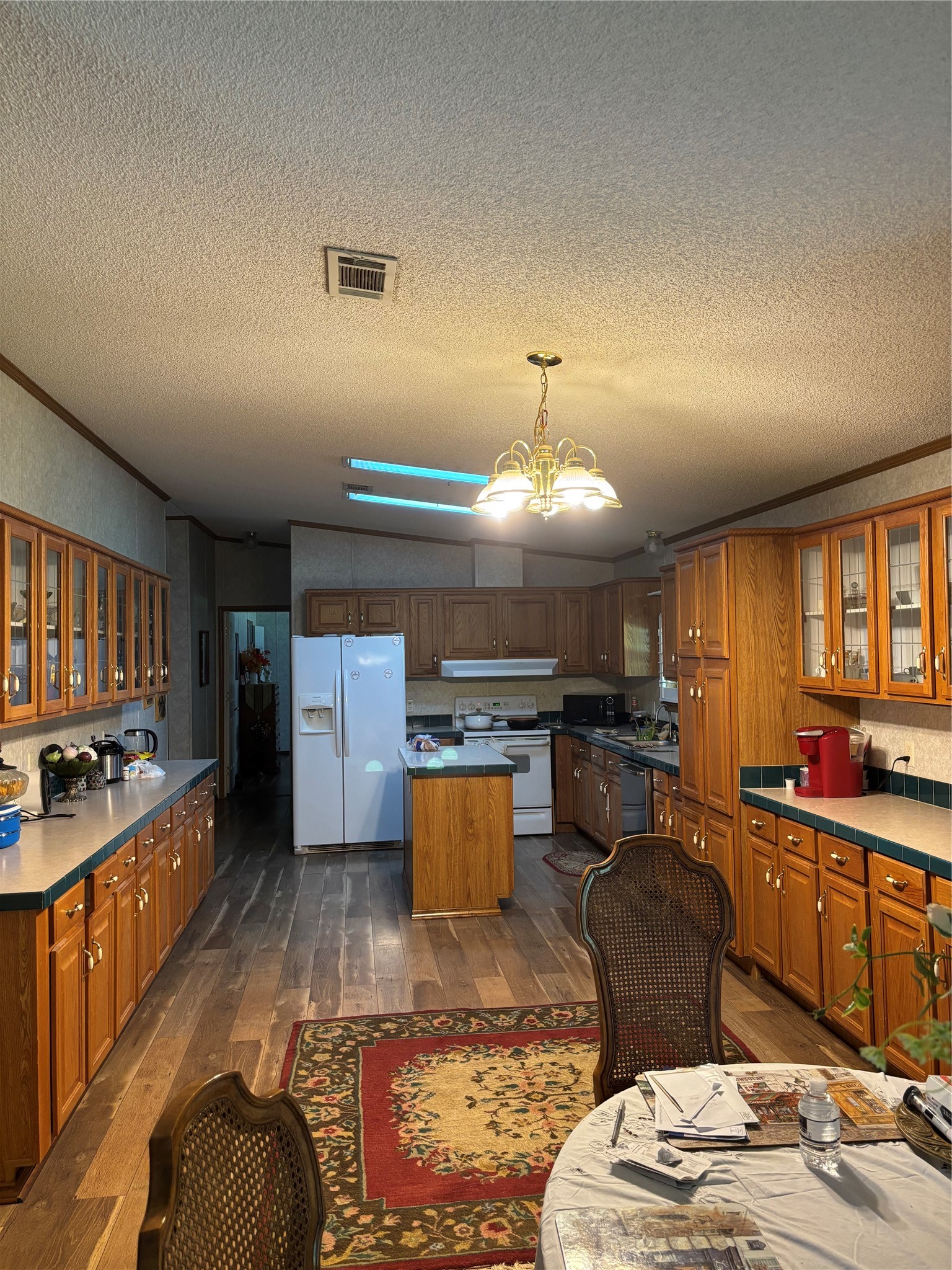 35599 State Highway South Buna, TX 77612 - Photo 18 of 40 a kitchen with a stove a refrigerator and wooden cabinets