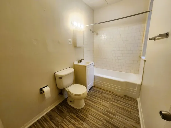 a bathroom with a toilet and a shower