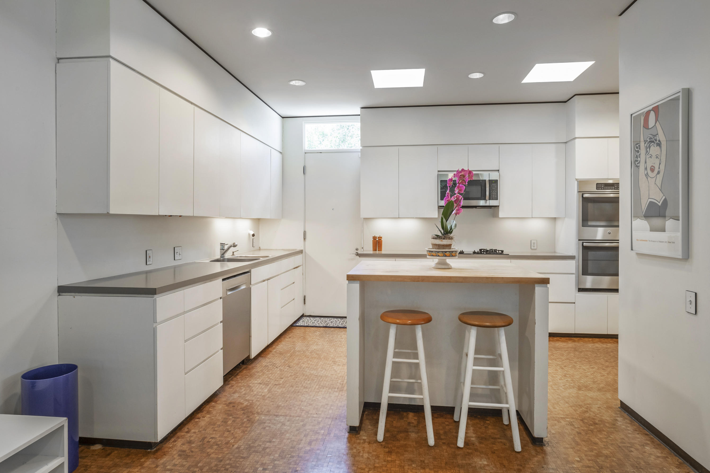 Undisclosed Address Montecito, CA 93108 - Photo 13 of 32 a kitchen with granite countertop a table chairs stove a sink and dishwasher