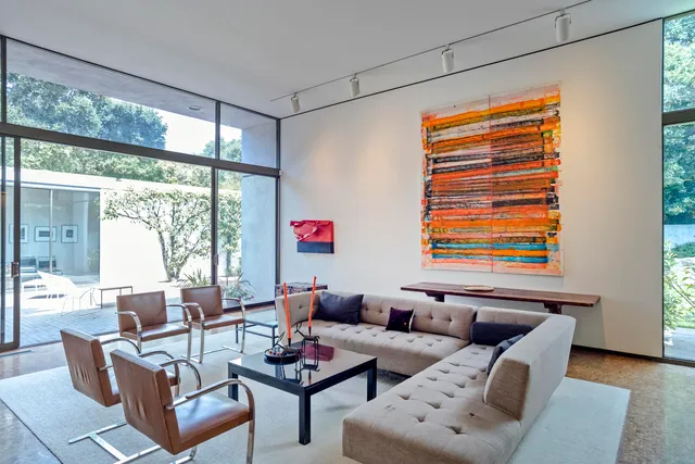 a living room with furniture and a floor to ceiling window