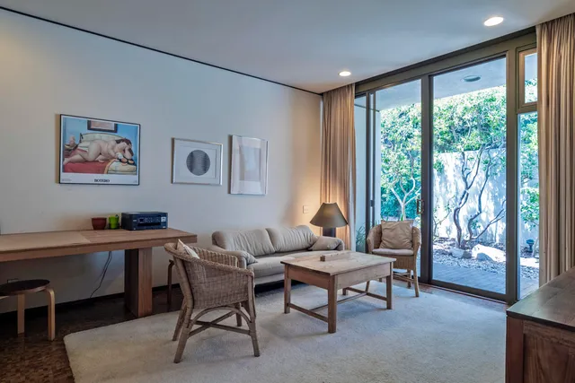 a living room with furniture and a book shelf