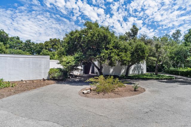a view of a yard with yellow house