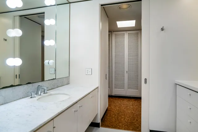 a bed room with a bed and a chair