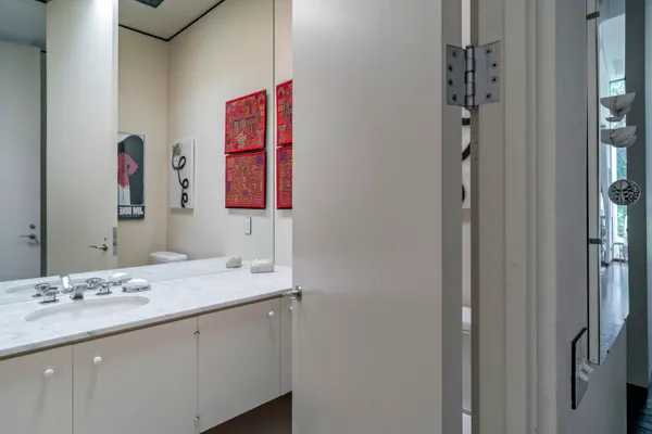 a en suite bathroom with a granite countertop sink and a mirror