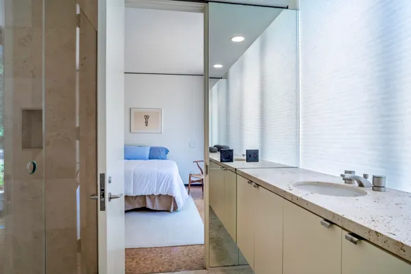 a spacious bedroom with a bed and a window
