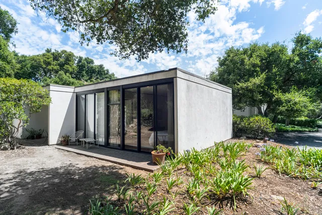 a view of a house with backyard sitting area and garden