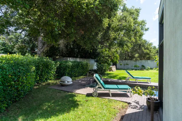 a view of backyard with tub and couches