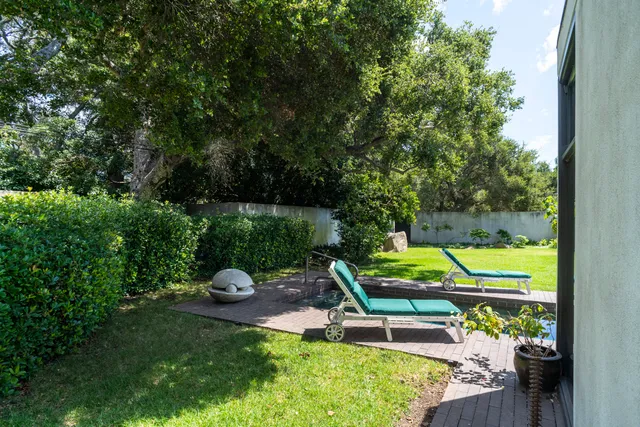 a view of backyard with tub and couches