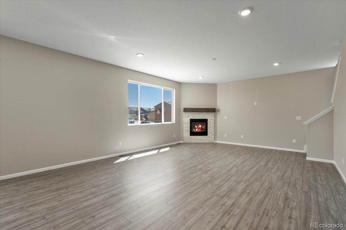 8178 Mount Harvard Road Littleton, CO 80125 - Photo 17 of 39 an empty room with wooden floor and a window