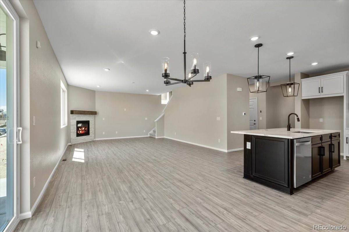 8178 Mount Harvard Road Littleton, CO 80125 - Photo 18 of 39 a large kitchen with granite countertop a large counter top a sink and stainless steel appliances