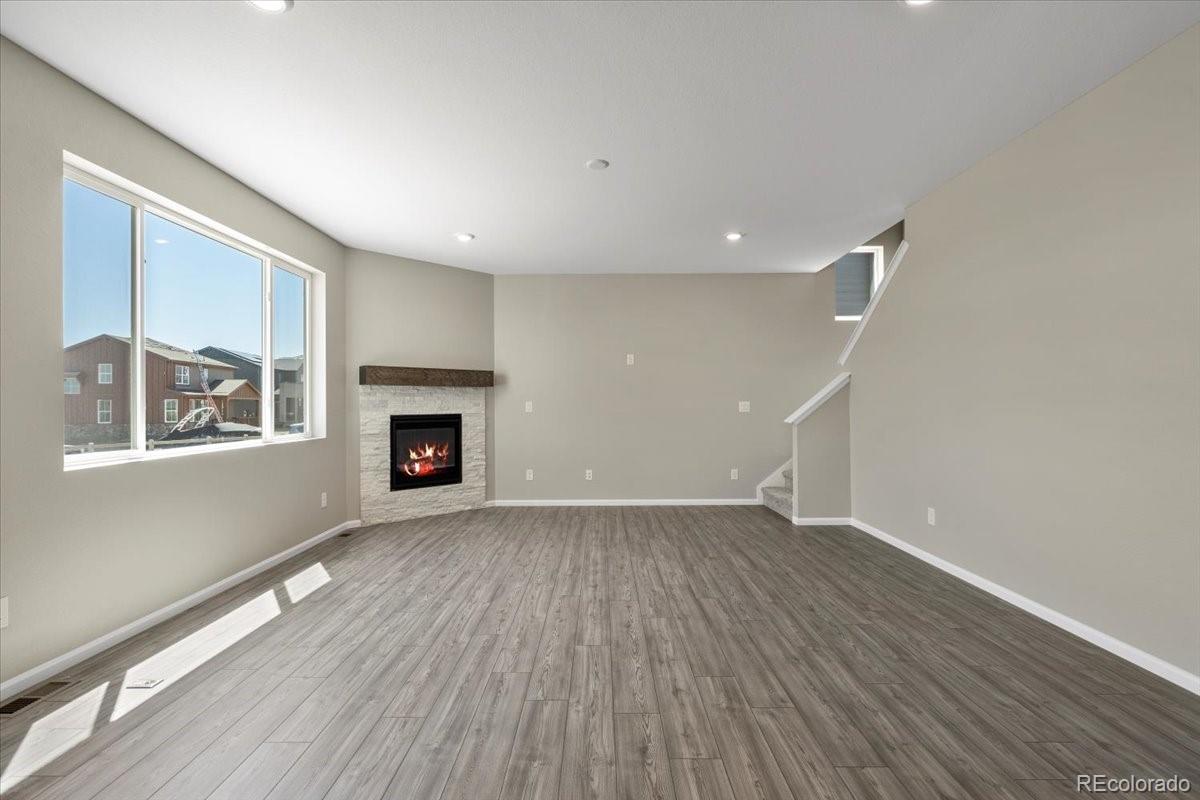8178 Mount Harvard Road Littleton, CO 80125 - Photo 19 of 39 a view of an empty room with wooden floor and a window