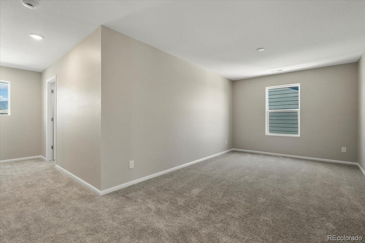 8178 Mount Harvard Road Littleton, CO 80125 - Photo 20 of 39 an empty room with windows