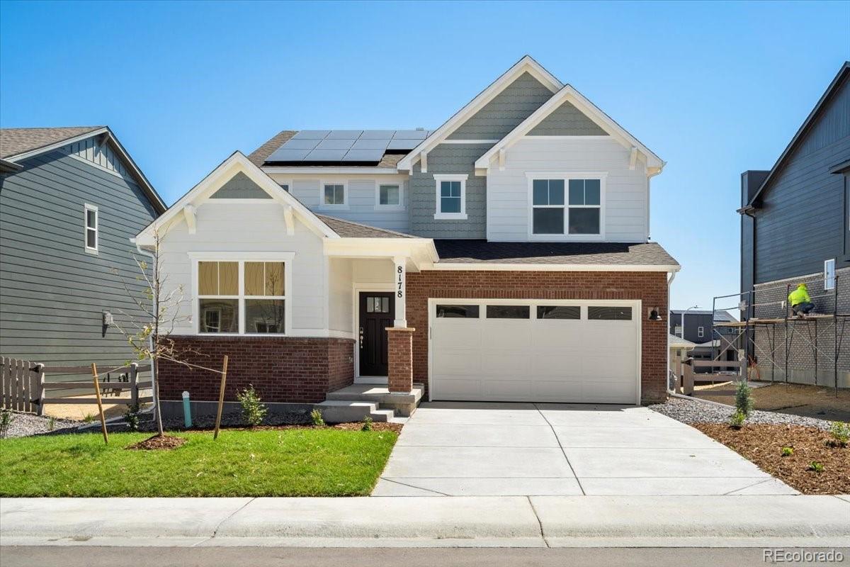 8178 Mount Harvard Road Littleton, CO 80125 - Photo 2 of 39 a front view of a house with a yard and garage