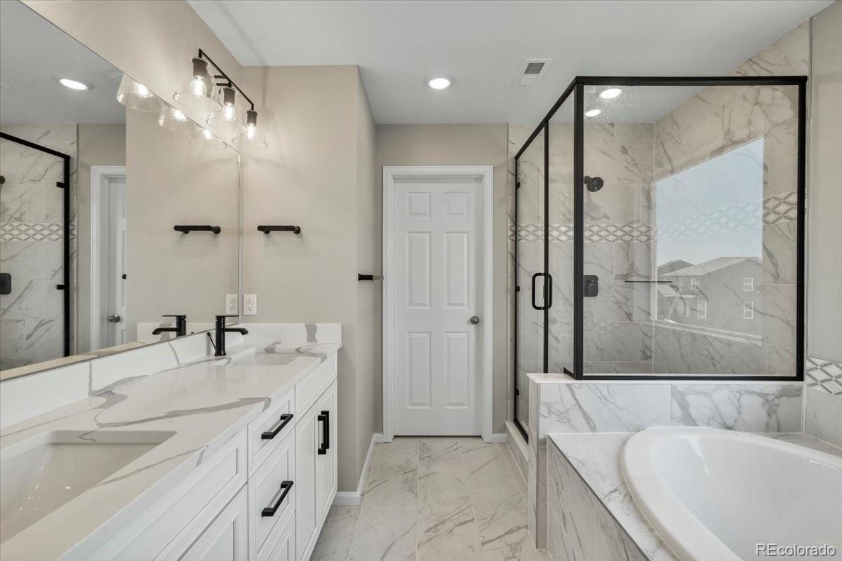 8178 Mount Harvard Road Littleton, CO 80125 - Photo 24 of 39 a bathroom with a granite countertop tub sink double vanity and shower