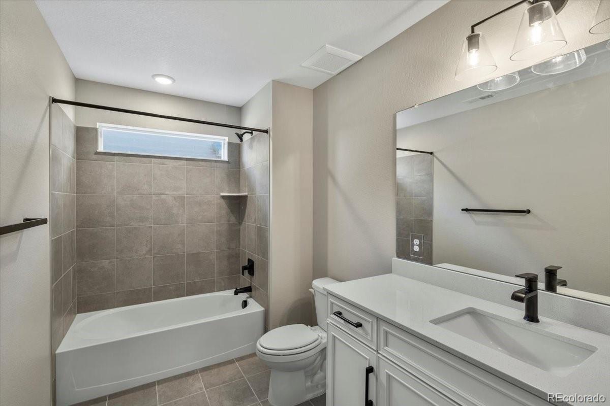 8178 Mount Harvard Road Littleton, CO 80125 - Photo 30 of 39 a bathroom with a sink a toilet and a bathtub