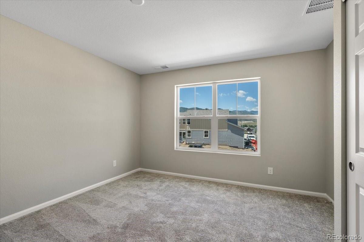 8178 Mount Harvard Road Littleton, CO 80125 - Photo 32 of 39 an empty room with a window