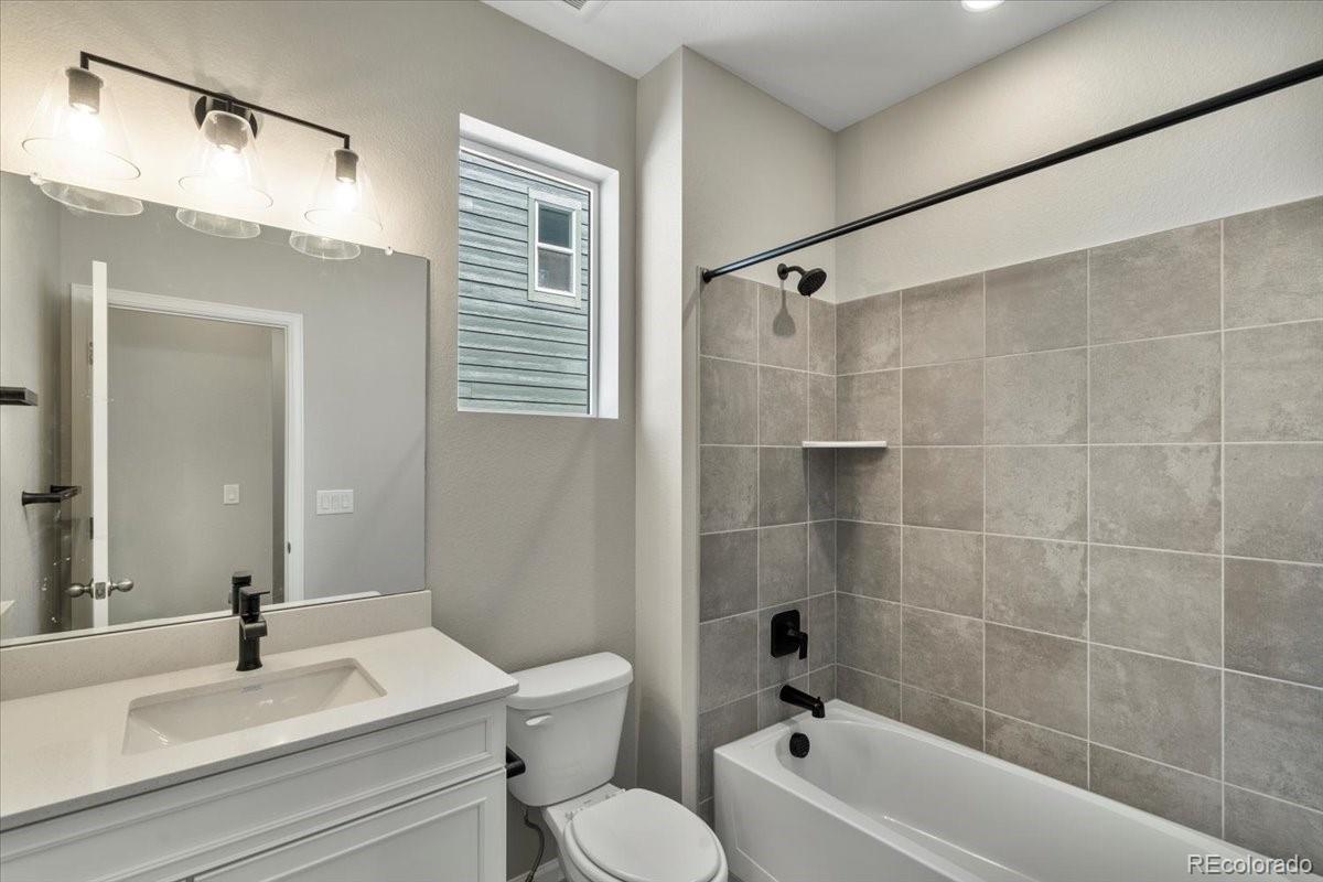 8178 Mount Harvard Road Littleton, CO 80125 - Photo 34 of 39 a bathroom with a sink a toilet and shower