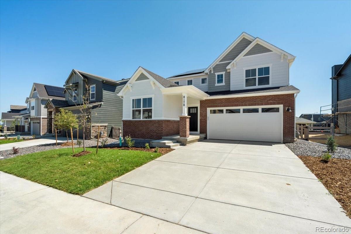 8178 Mount Harvard Road Littleton, CO 80125 - Photo 4 of 39 a front view of a house with a garden and yard