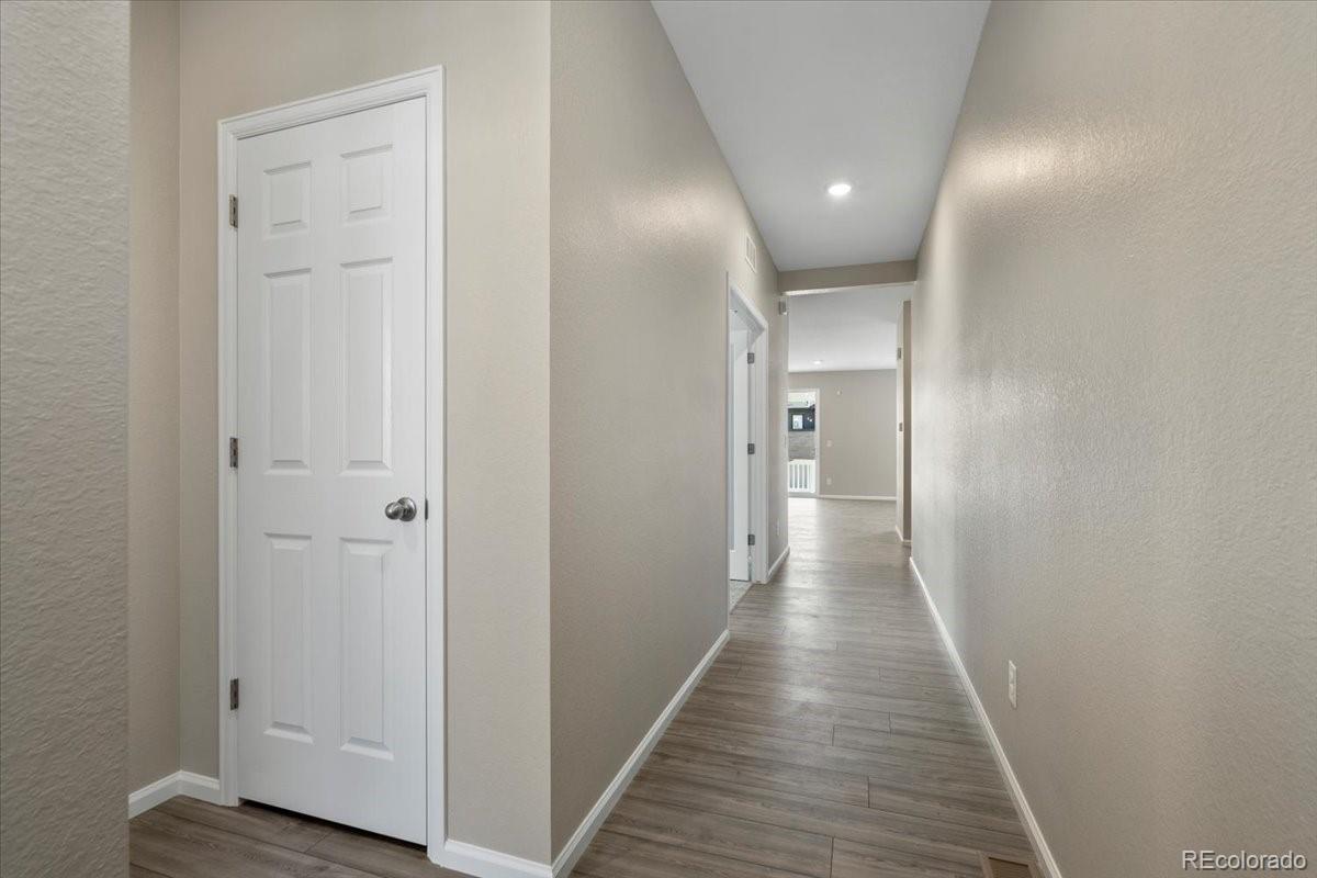 8178 Mount Harvard Road Littleton, CO 80125 - Photo 7 of 39 a view of a hallway with wooden floor