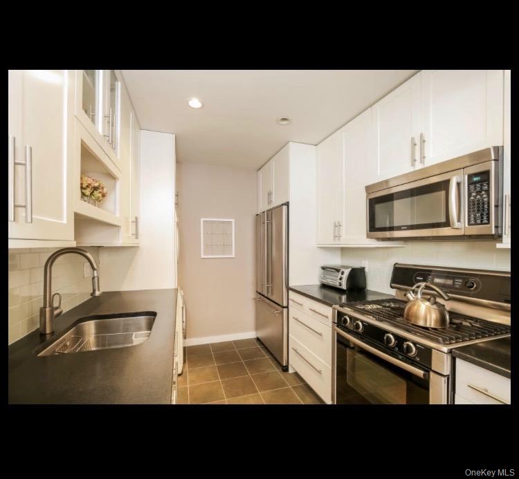 21 Hillside Terrace, Unit C White Plains, NY 10601 - Photo 13 of 18 Kitchen with stainless steel appliances, white cabinets, and recessed lighting