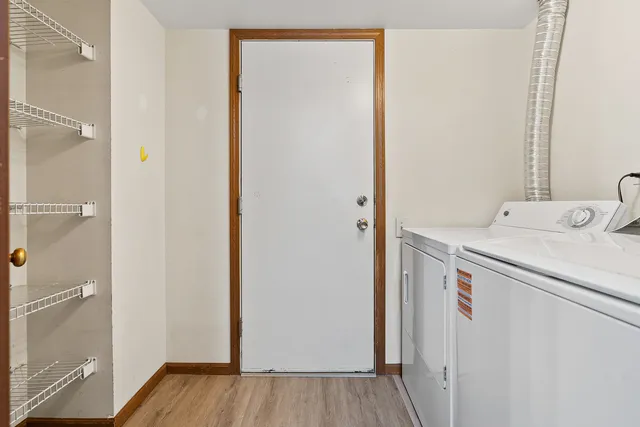 a utility room with cabinets washer and dryer