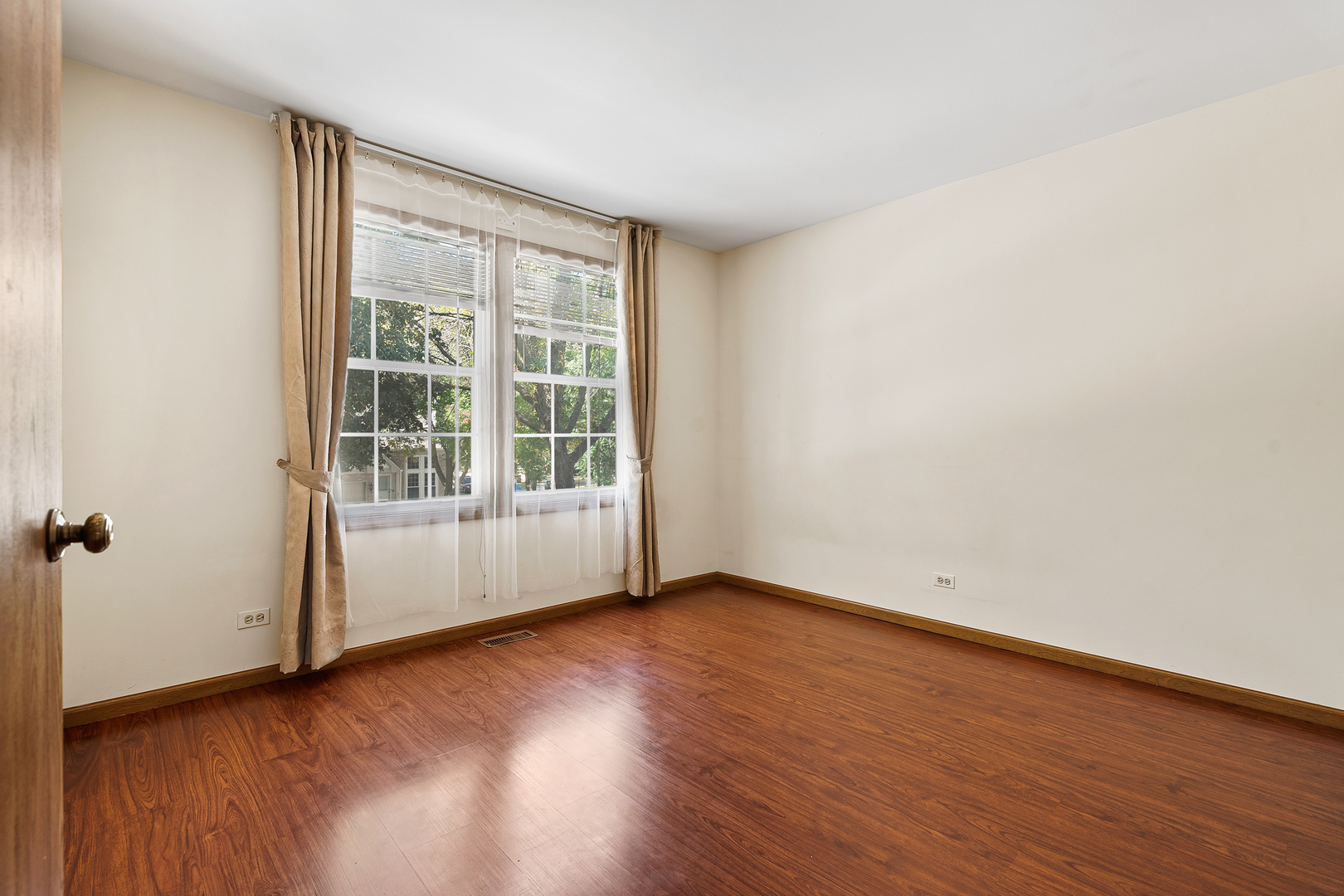 1404 West Sapphire Drive Hoffman Estates, IL 60192 - Photo 23 of 29 an empty room with wooden floor and windows