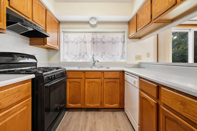 a kitchen with granite countertop cabinets stainless steel appliances and a counter space