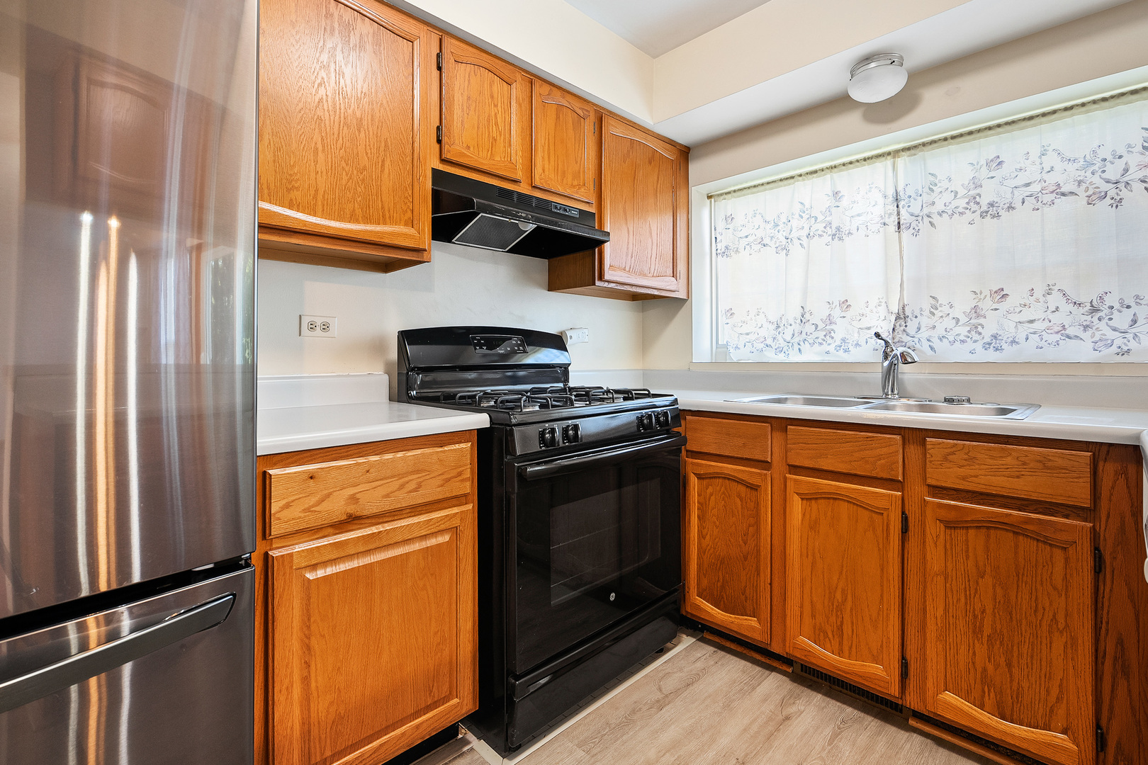 1404 West Sapphire Drive Hoffman Estates, IL 60192 - Photo 9 of 29 a kitchen with stainless steel appliances granite countertop a refrigerator sink and cabinets