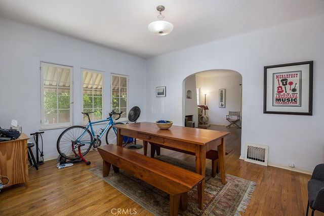 a room with furniture a dining table and a large window