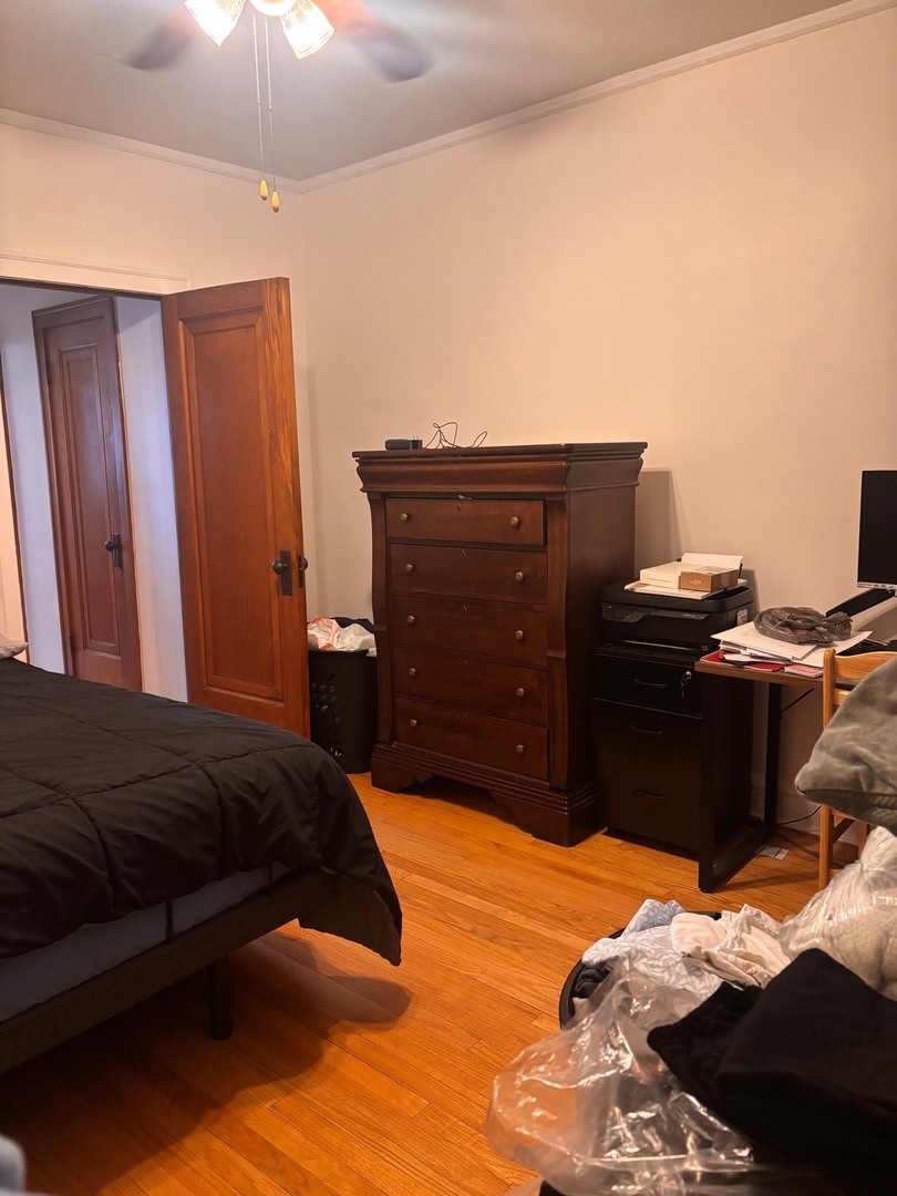 6832 West Medill Avenue, Unit 5 Chicago, IL 60707 - Photo 11 of 16 a bedroom with a bed and a chandelier