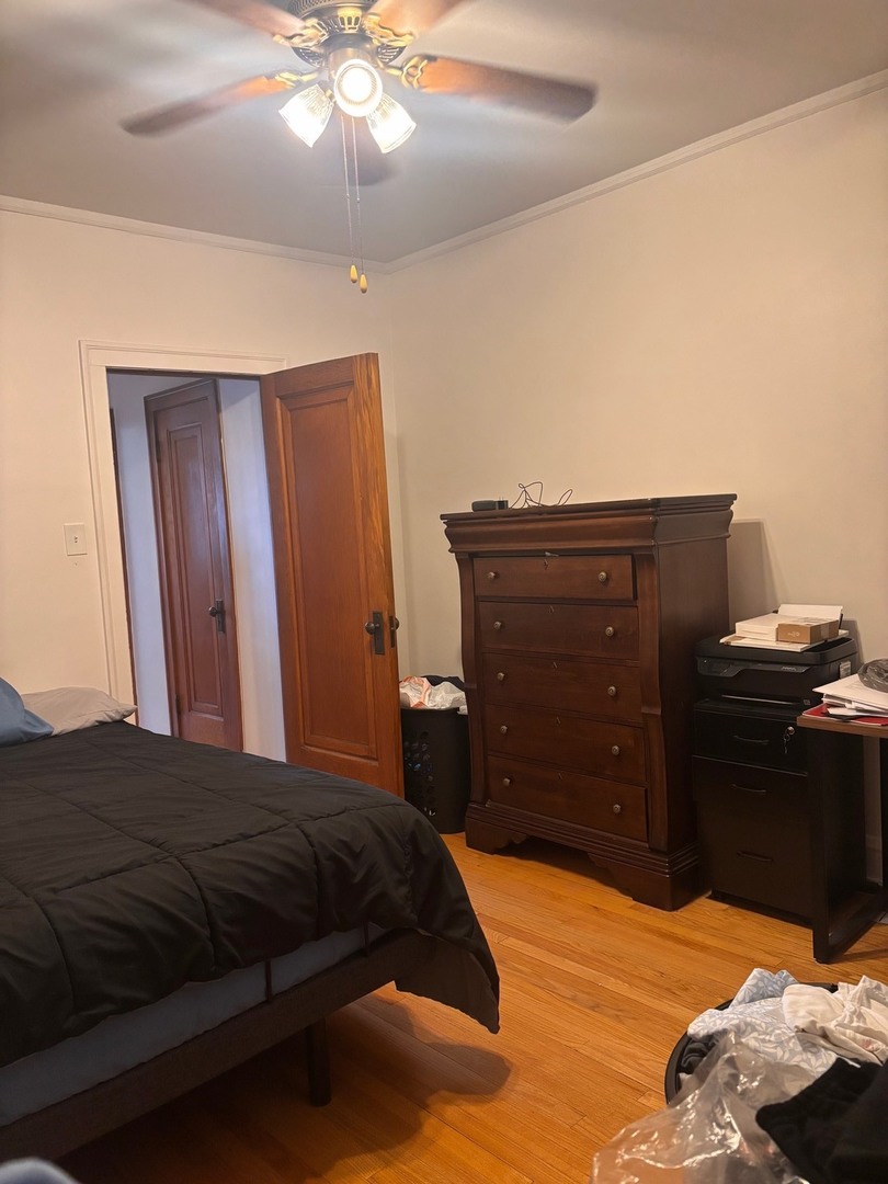 6832 West Medill Avenue, Unit 5 Chicago, IL 60707 - Photo 12 of 16 a bedroom with a bed and a dresser
