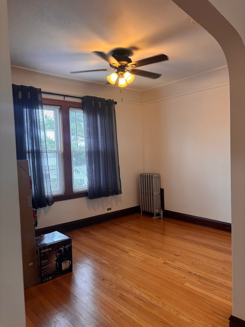 6832 West Medill Avenue, Unit 5 Chicago, IL 60707 - Photo 16 of 16 a view of an empty room with wooden floor and a window