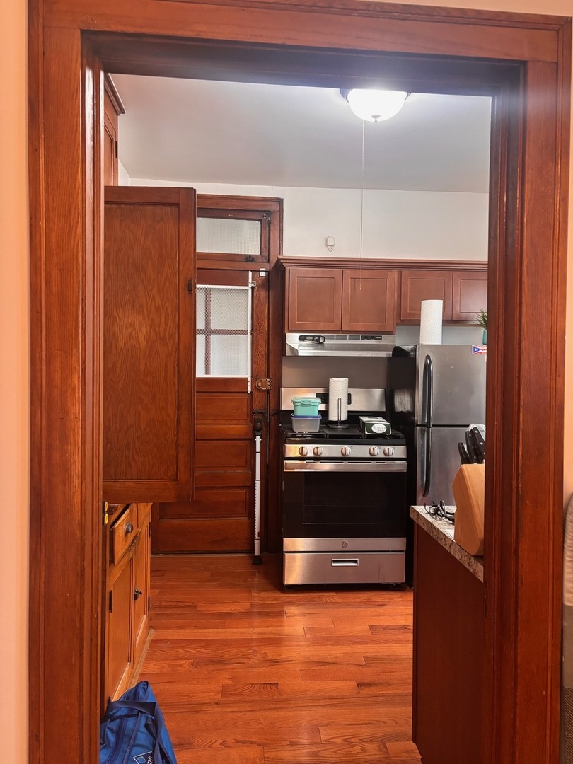 6832 West Medill Avenue, Unit 5 Chicago, IL 60707 - Photo 2 of 16 a kitchen with stainless steel appliances granite countertop a stove and a refrigerator