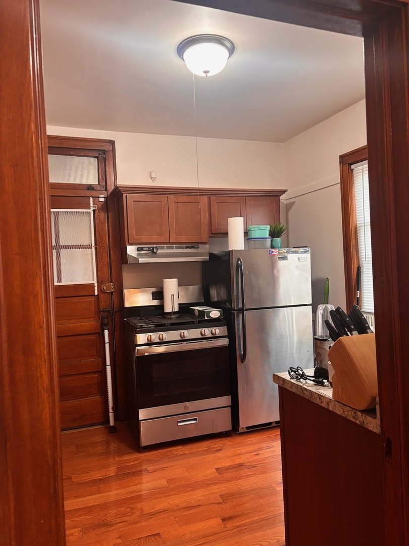 6832 West Medill Avenue, Unit 5 Chicago, IL 60707 - Photo 3 of 16 a kitchen with stainless steel appliances granite countertop a refrigerator stove and oven