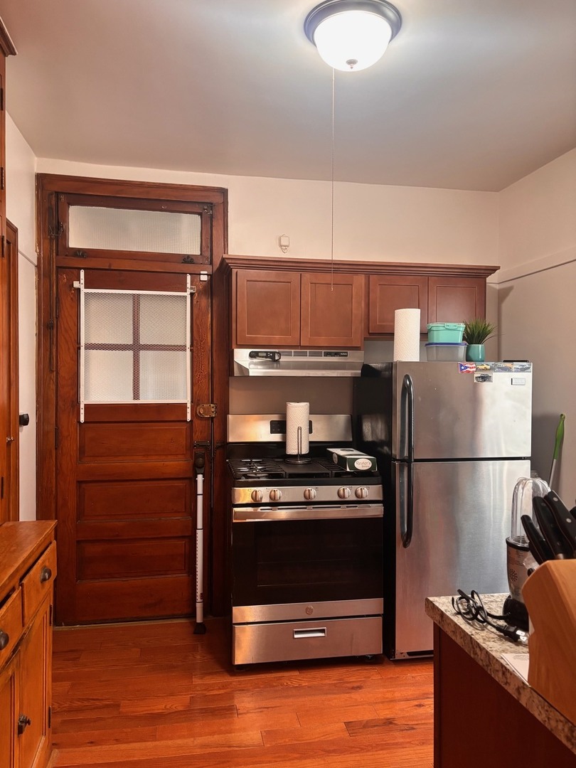 6832 West Medill Avenue, Unit 5 Chicago, IL 60707 - Photo 4 of 16 a kitchen with a refrigerator and a stove