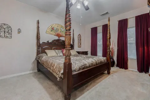 a bedroom with a bed and window