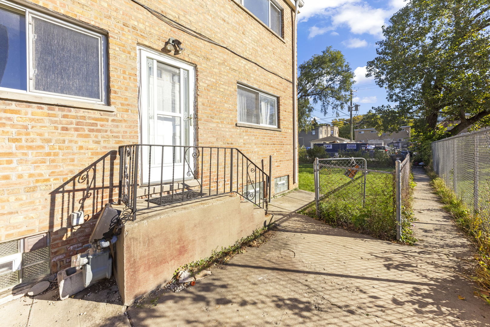 a view of a house with wooden floor next to a yard