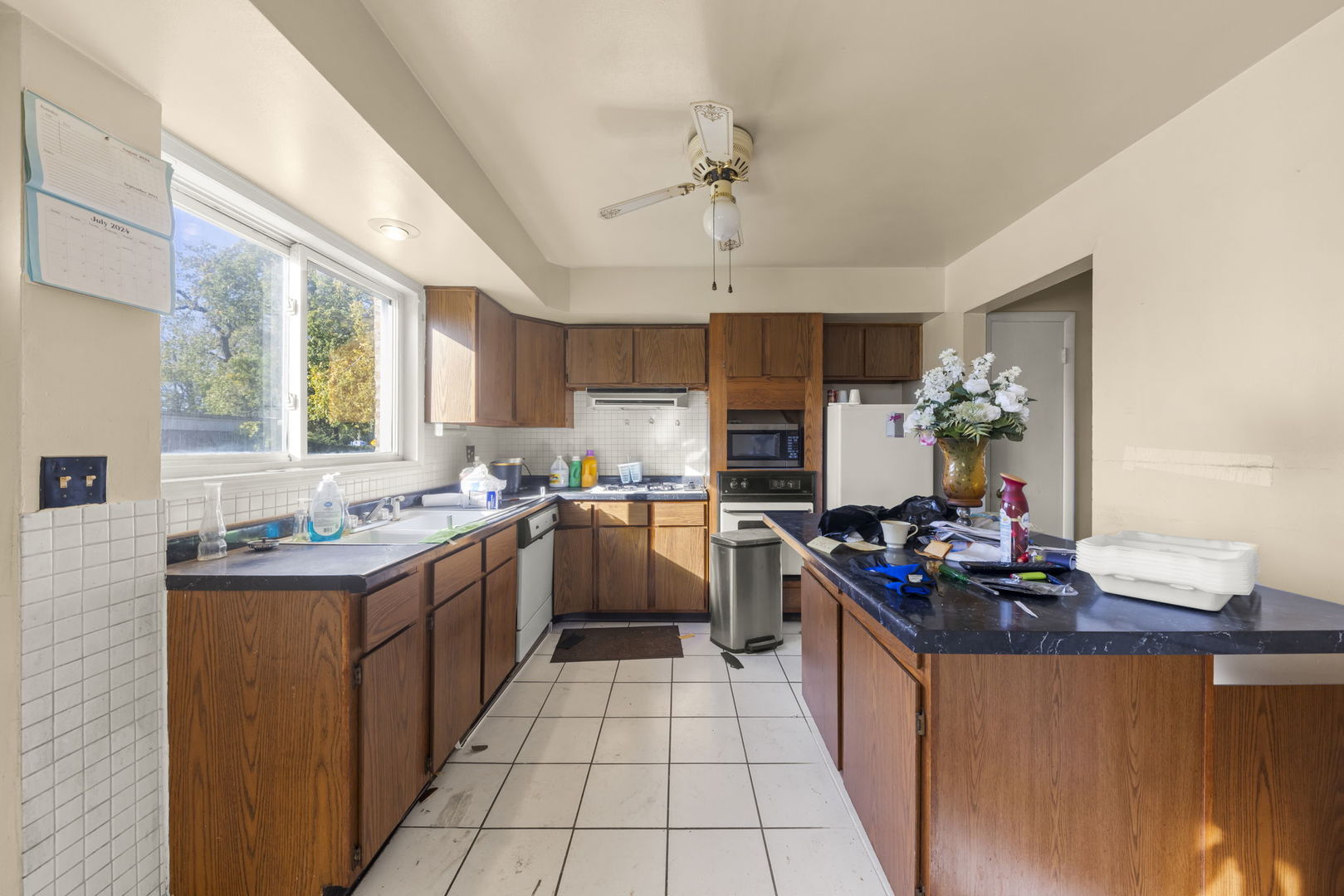 1311 Mcdaniel Avenue, Unit C Evanston, IL 60201 - Photo 10 of 40 a kitchen with kitchen island granite countertop a sink stove and refrigerator