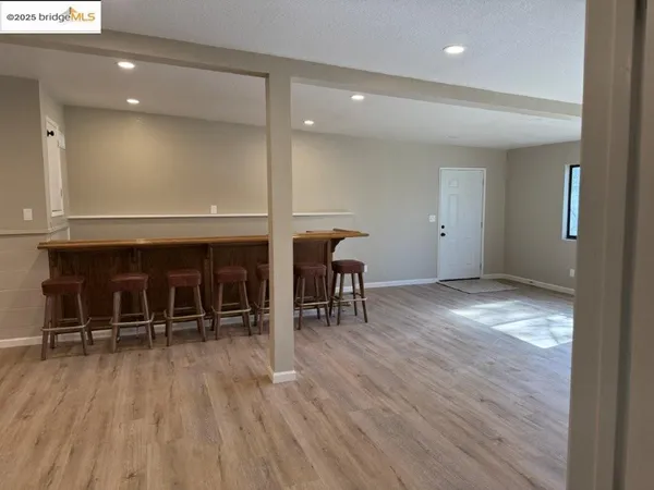 an empty room with wooden floor and furniture