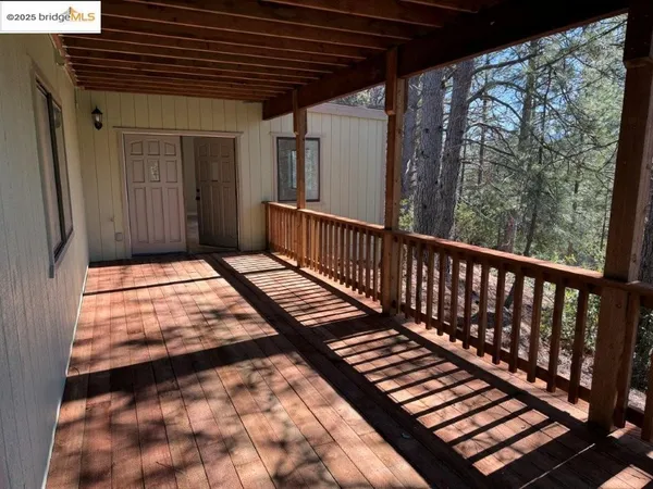 a view of balcony with wooden floor