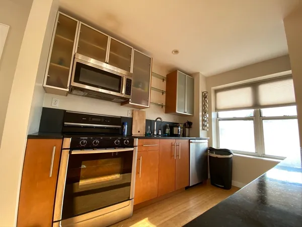 a kitchen with stainless steel appliances a stove a microwave and a counter top