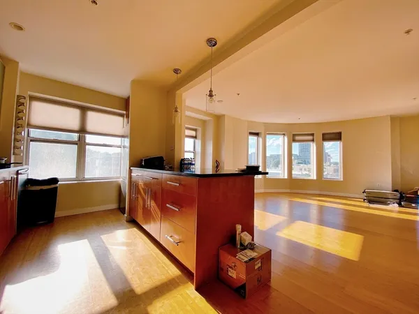 a living room with furniture pool table and a large window