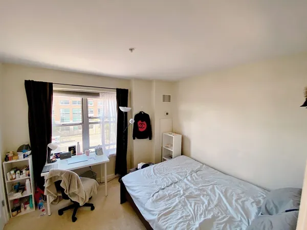 a bedroom with a bed and a chair