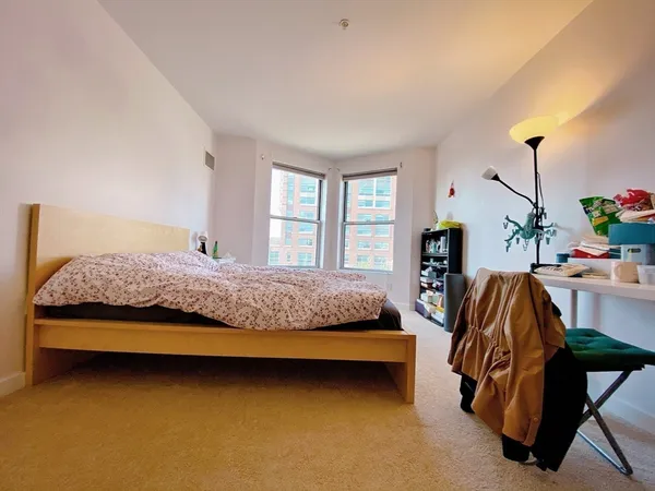 a bedroom with a bed and ceiling fan